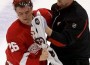 Jiri Hudler is helped off the ice by team therapist Piet Van Zant after Mike Brown's late hit during Detroit's 3-2 win at Joe Louis Arena on Friday. (ANDRE J. JACKSON/DFP)