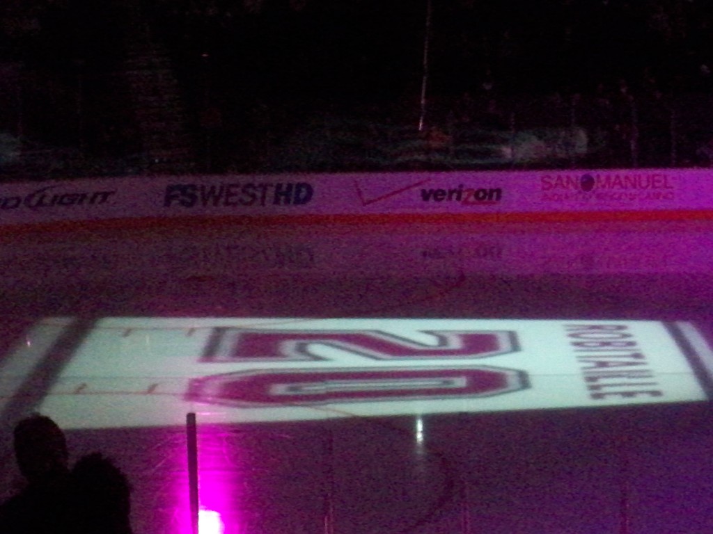 Luc's jersey number projected on the ice