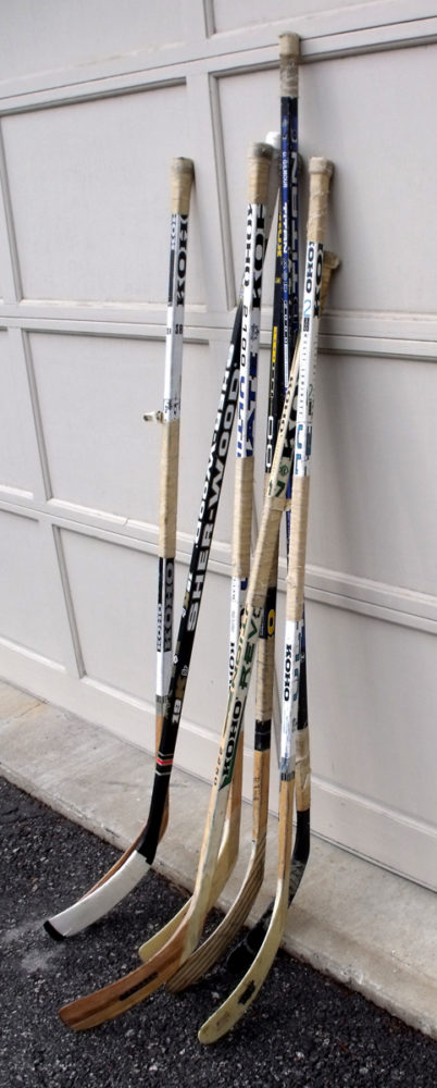 Sticks resting while road hockey players have lunch. (Mark Ascione)