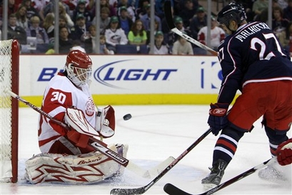 Detroit Red Wings' Chris Osgood, left, makes a save against Columbus Blue Jackets' Manny Malhotra during the second period of an NHL hockey game Sunday, March 15, 2009, in Columbus, Ohio. Photo courtesy of AP