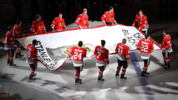Blackhawks skate their Stanley Cup banner across United Center ice