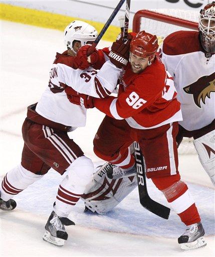 Coyotes Adrian Aucoin takes on Red Wings Tomas Holmstrom in the 2010 NHL Playoffs (AP Phote/Carlos Osorio)
