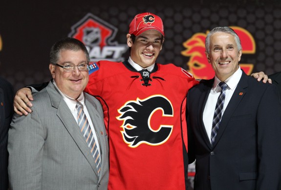 Sean Monahan tries to get his arm around Jay Feaster (Ed Mulholland-USA TODAY Sports)