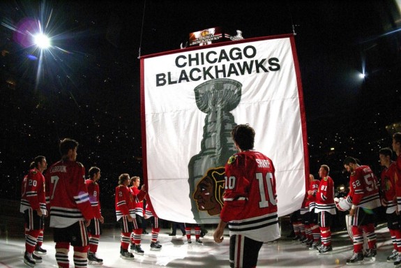 Oct 1, 2013; Chicago, IL, USA; Chicago Blackhawks center Patrick Sharp (10) stands with teammates as the 2013 Stanley Cup championship banner is raised to the rafters before the game against the Washington Capitals at the United Center. Mandatory Credit: Rob Grabowski-USA TODAY Sports