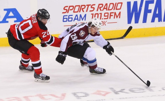 Ryan Carter works against Nathan McKinnon of the Colorado Avalanche. (Ed Mulholland-USA TODAY Sports)
