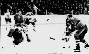 Terry Sawchuk stops Claude Provost in action from last night's game in Montreal.