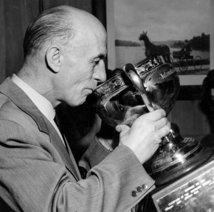 Eddie Shore sips from the Calder Cup.