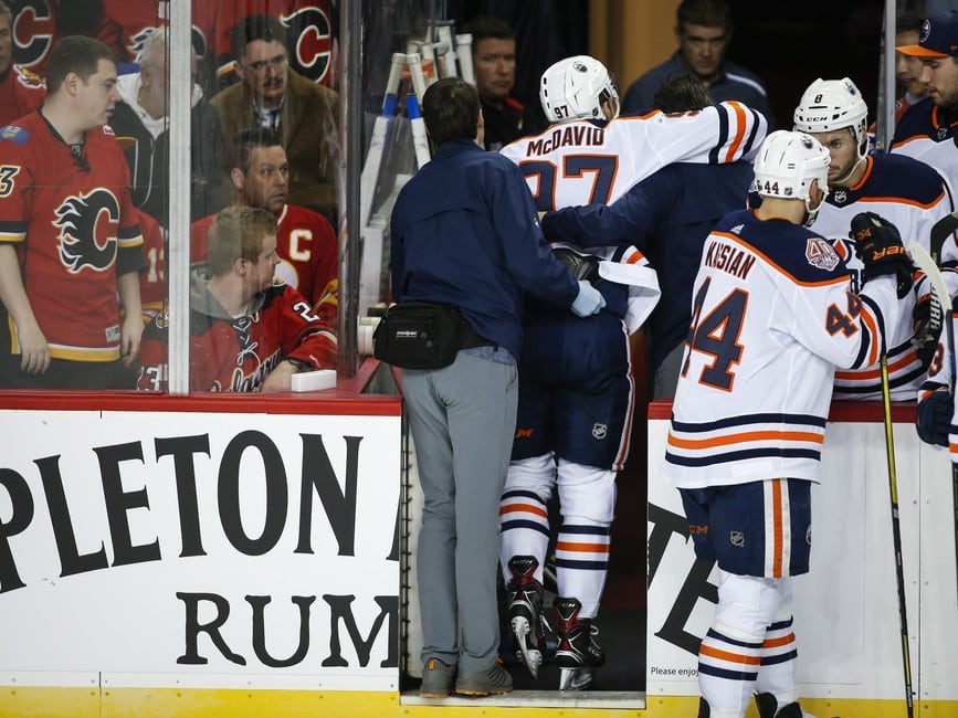 Edmonton Oilers' Connor McDavid is helped off the ice