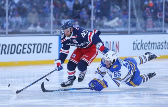 New York Rangers right wing Michael Grabner followed by a falling Buffalo Sabres defender Rasmus Ristolainen during the 2018 winter classic