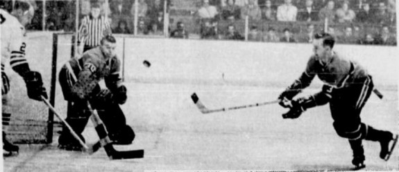 J.C. Tremblay retrieves puck in front of Gump Worsley. Doug Mohns is at left.