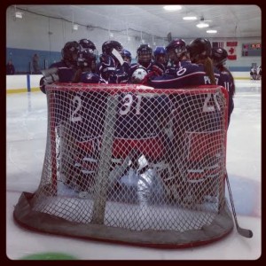 Ohio AAA Blue Jackets Girls gather round the net for a pregame meeting. (Photo Credit: Elaine Shircliff) 