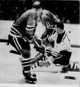Bobby Hull (9) and Bill Hay buzz around Boston goalie Ed Johnston last night.
