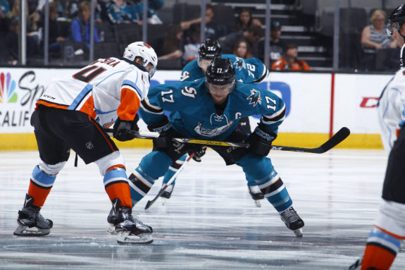 John McCarthy and Kalle Kossila prepare for a faceoff in Game 2